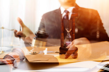 Judge gavel with Justice lawyers having team meeting at law firm in background. Concepts of law.