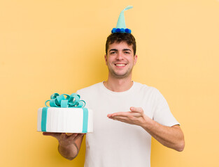 young handsome man smiling cheerfully, feeling happy and showing a concept. birthday  concept