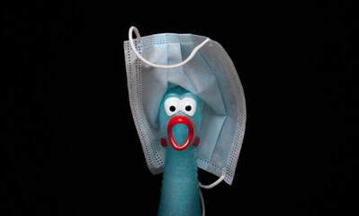 image of rubber chicken mask dark background 