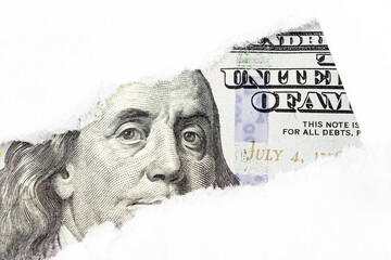 One hundred dollars bill fragment, Benjamin Franklin portrait on 100 banknote in torn paper hole. New sample money.