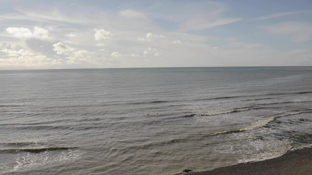 English Channel at Birling Gap with surfers in water.