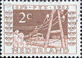Netherlands - circa 1952: a postage stamp from the Netherlands , showing a Telegraph Lines and steam Railways (1852) . brown 2 cent - obrazy, fototapety, plakaty