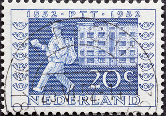 Netherlands - circa 1952: a postage stamp from the Netherlands , showing mail delivery in modern...