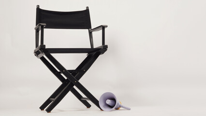 Black director chair and megaphone on white background.