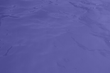 blue water wave texture background. Rippled water. Shiny purple and blue water surface.