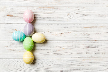 holiday preparation Multi colors Easter eggs on colored background, cross show the religious and secular side of Easter. Pastel color Easter eggs. holiday concept with copy space