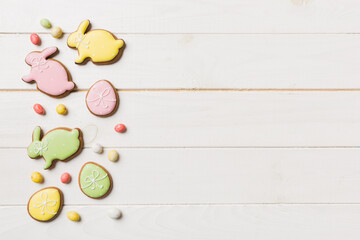 holiday preparation Multi colors Easter eggs with cookies on colored background . Pastel color Easter eggs. holiday concept with copy space
