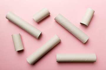 Empty toilet paper roll on colored background. Recyclable paper tube with metal plug end made of kraft paper or cardboard