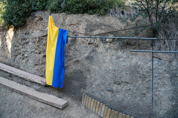 Ukrainian flag desolated on the ground. 