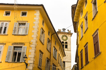 Fototapeta na wymiar A clock tower gate - the Torre Civica or Civic Tower - in the historic centre of Rovereto in Trentino, north east Italy 