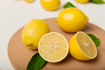 Fototapeta na wymiar Top view with copy space for fresh and ripe lemons on cutting board. Healthy food background. Elegant background of lemon and lemon slices with squeezer colored background