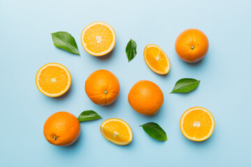 Fruit pattern of fresh orange slices on colored background. Top view. Copy Space. creative summer concept. Half of citrus in minimal flat lay