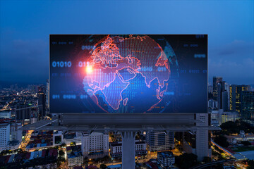 Hologram of Earth planet map on billboard over night panoramic cityscape of Kuala Lumpur, Malaysia, Asia. The concept of international companies in KL. Globe