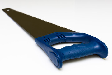 Obraz premium wood saw with a blue plastic handle on a white background