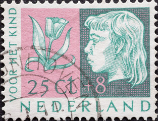 Netherlands - circa 1953: a postage stamp from the Netherlands , showing a portrait of a Girls Head...