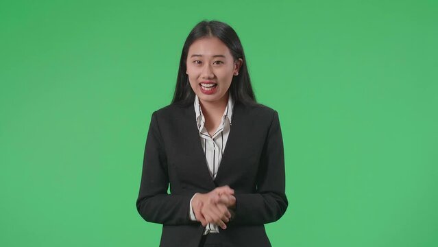 Asian Businesswoman In Suit Jacket Standing And Presenting Something On The Green Screen Background
