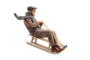 Elderly man riding on a wooden sleigh
