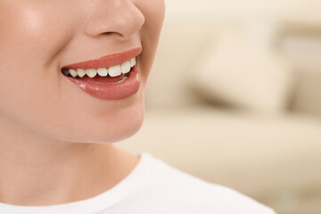 Woman with healthy teeth on blurred background, closeup. Space for text