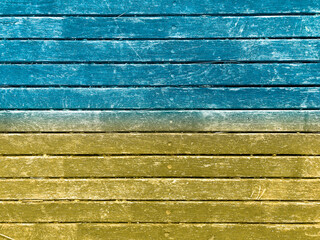 Ukrainian flag painted on wooden background. Yellow blue wall texture background. Grunge yellow blue wall background. Abstract grunge background.
