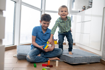 Two kids playing with construction toys at home