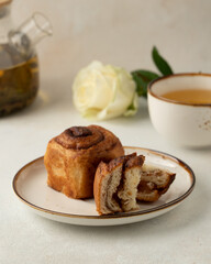 cut of the cruffin with cinnamon and cup of tea