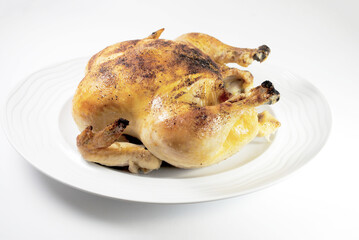 Whole Roasted Chicken on a Round White Platter	