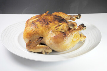 Whole Roasted Chicken on a Round White Platter	