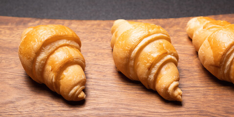 Fresh croissants on a wooden board. Fresh bakery croissants.selective focus.