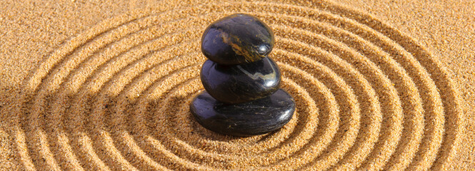 Japanese ZEN garden with yin yang stone in textured sand