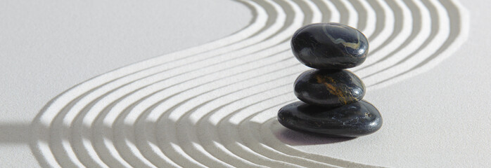 Fototapeta na wymiar Japanese ZEN garden with yin yang stone in textured sand