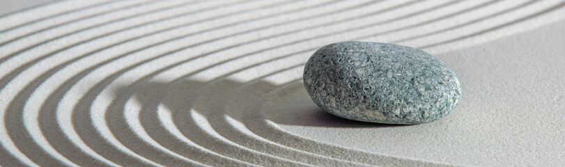 Japanese ZEN garden with yin yang stone in textured sand