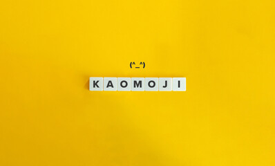 Kaomoji Word on Letter Tiles and Emoticon on Yellow Background. Minimal Aesthetics.