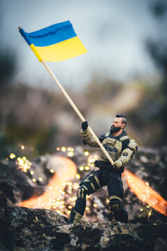 soldado ucraniano ondeando la bandera victoriosa entre llamas frente al invasor ruso