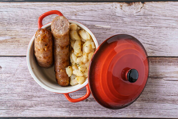 Sausages with white beans, in catalan butifarra con mongetes, typical dish from catalonia, spain....