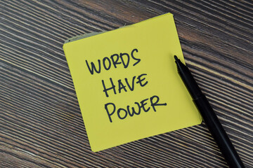 Words Have Power write on sticky notes isolated on Wooden Table.