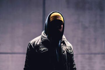 Hooded criminal in dark. Mystery man with hood. Gangster in urban street. Hooligan in hoodie....