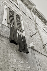 Clothesline with pants on a facade in the old town of Krk in Croatia
