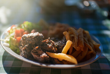 Traditional Greek Beef Stifado with rice and french fries.