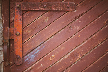 massive old red painted wooden double door or garage gate