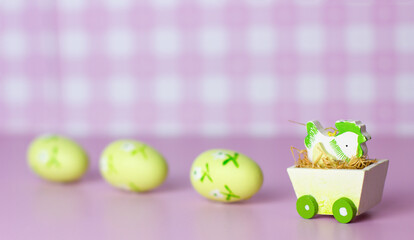 Easter card with chick and eggs on pink background with copyspace