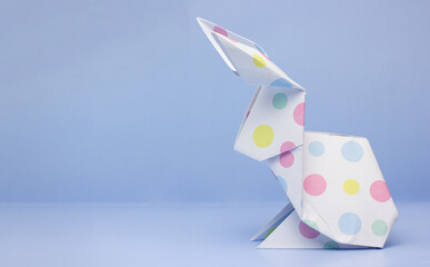 Easter paper origami bunny on blue background
