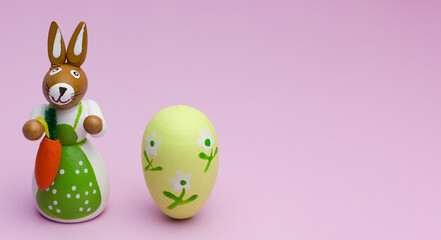 Easter mom rabbit with egg on pink background with copyspace