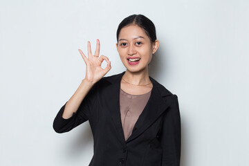 Asian business woman with ok sign gesture tumb up on white background
