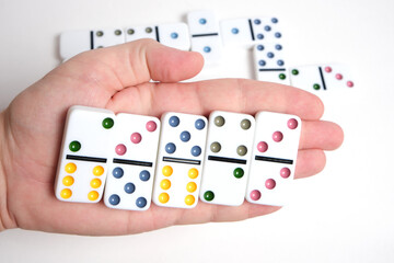Dominoes in hand, playing dominoes leisure and hobby.