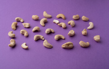 Cashew nuts on a purple background