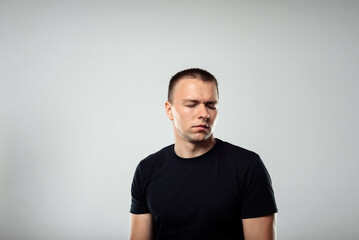 Closeup portrait of young grumpy man, Negative emotions, facial expression feelings, body language.