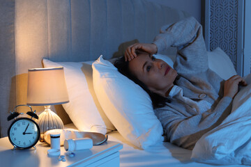 Mature woman suffering from insomnia in bed at night