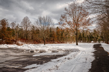 Snow builds up around the edges of this parking lot.  Partially plowed parking are at Cole Park in...