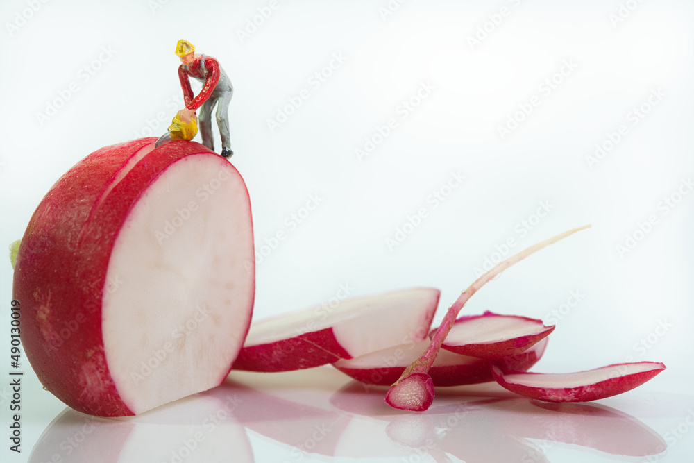 Aufkleber a worker stands on a radish and cuts them into slices with a chainsaw. side view