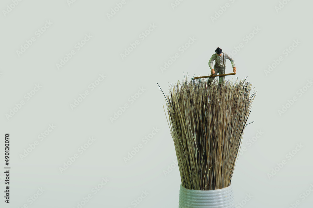 Poster a farmer works with a scythe on a brush